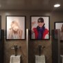 Pictures above the urinals at a bar.